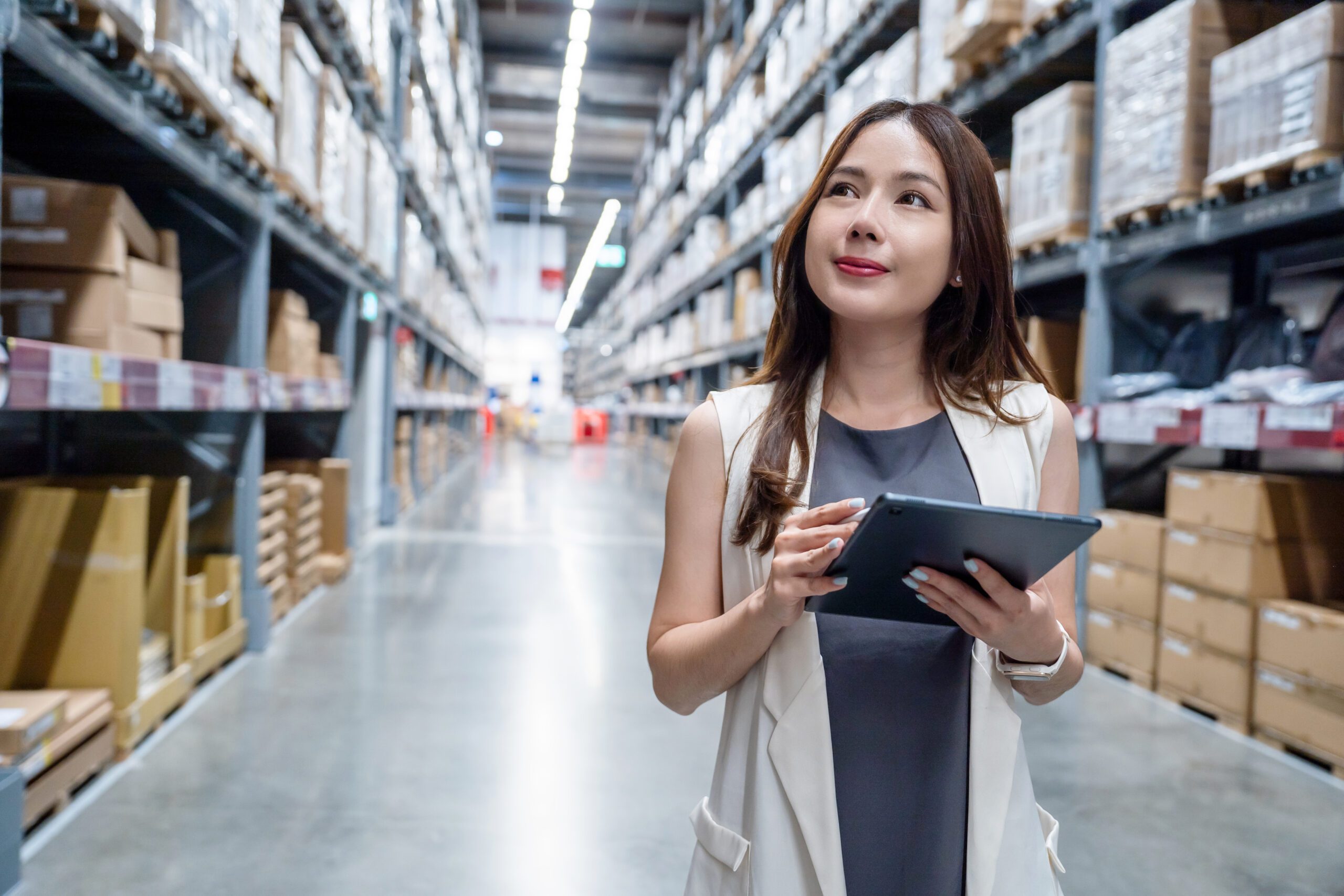 Asian female business owner checking goods in a warehouse waiting for distribution Logistic business transportation service and logistics delivery Asian female business owner checking goods in a warehouse waiting for distribution Logistic business transportation service and logistics delivery