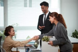 Cheerful Colleagues Greeting Employee